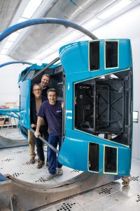 lamborghini countach restorers standing inside of body