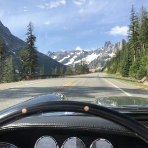 vintage maserati vignale spyder open road and snow capped mountain view
