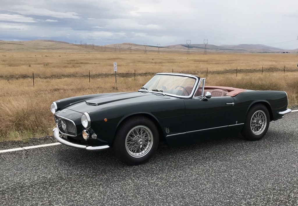 vintage maserati vignale spyder front three-quarter beside long grass field