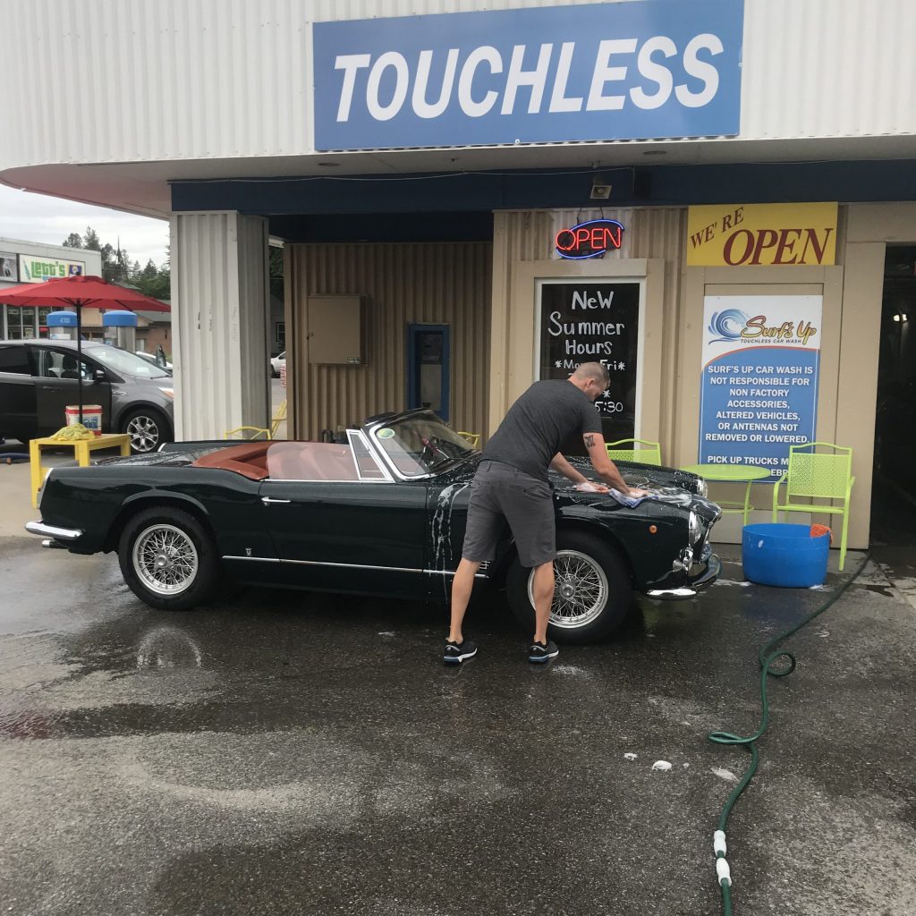 man hand drying vintage maserati vignale spyder