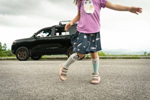 Girl Dances Before Toyota Land Cruiser