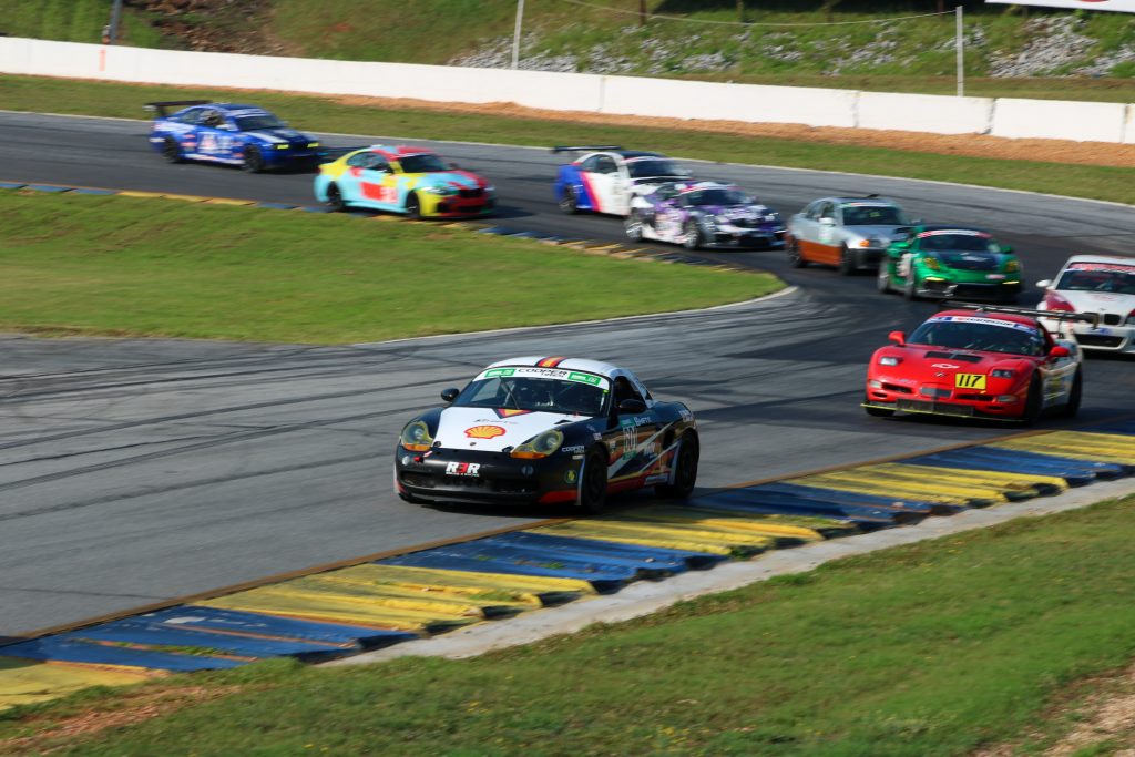 shift up motorsports on track action porsche leading pack