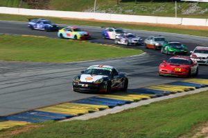 shift up motorsports on track action porsche leading pack