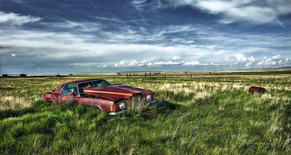 1974 Pontiac Grand Prix in grassy field plains wyoming usa