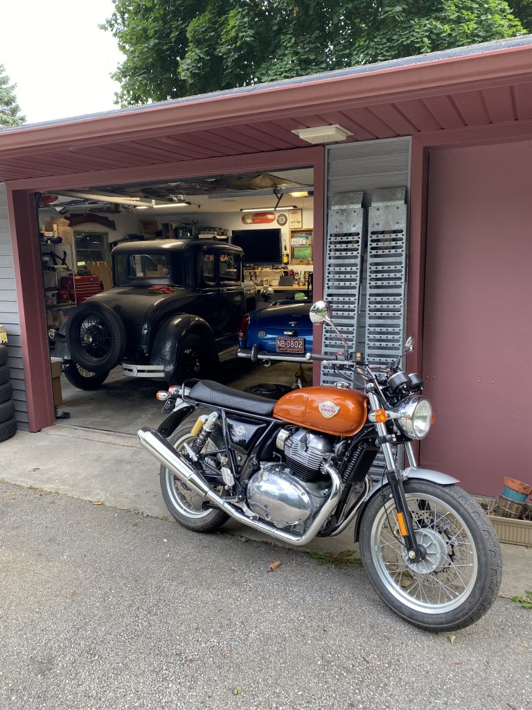 Royal Enfield INT650 in front of garage