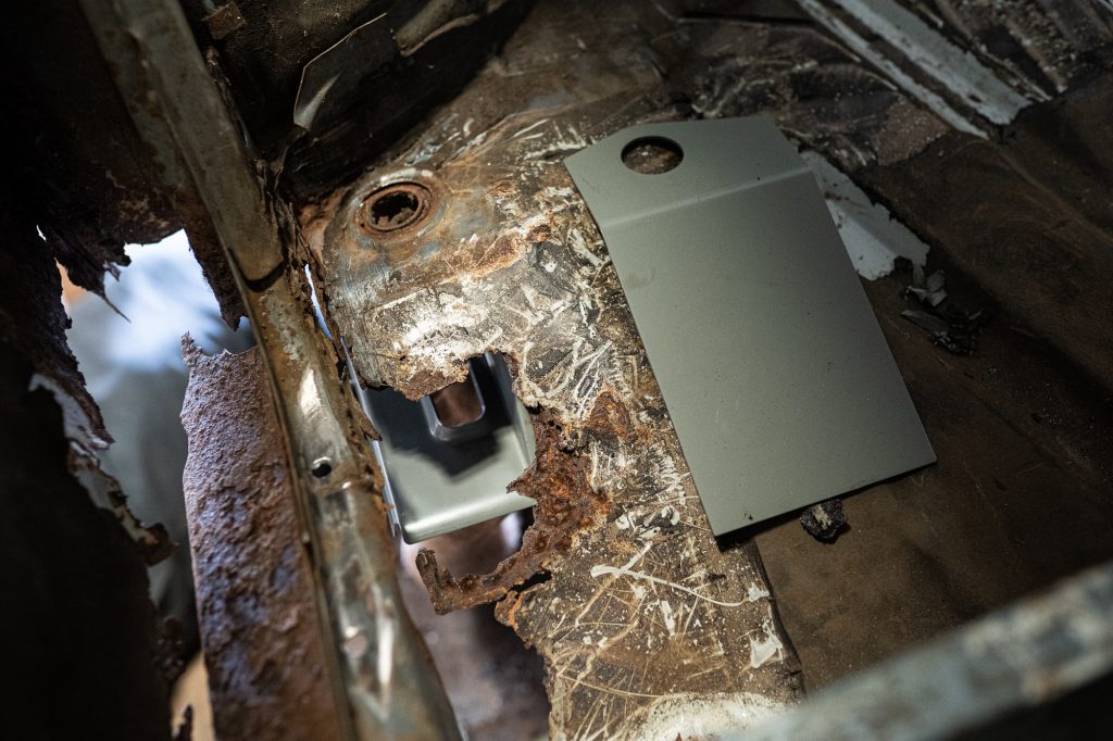 metal plate beside rotted floor of bmw 2002