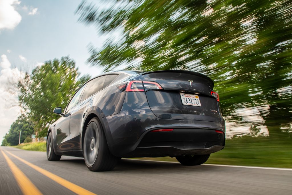 Tesla Model Y rear three-quarter dynamic road action