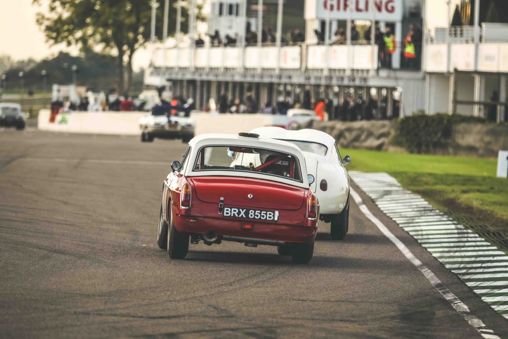 goodwood speedweek two tone red white coupe rear racing action