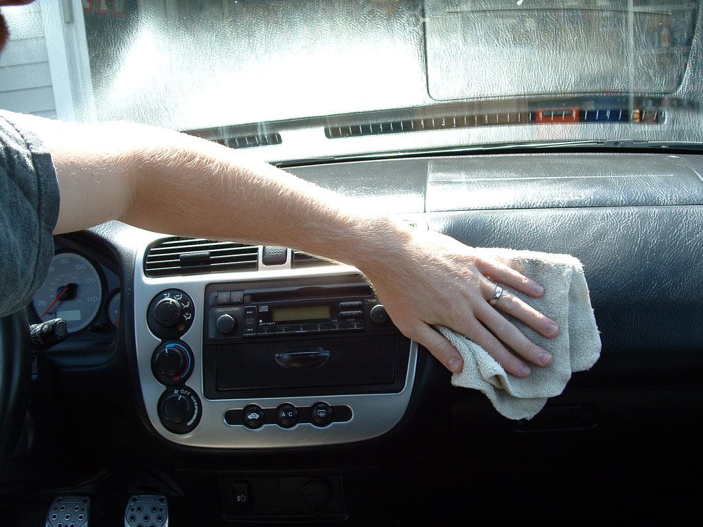 Car dashboard cleaning with microfiber cloth Car dashboard cleaning with microfiber cloth