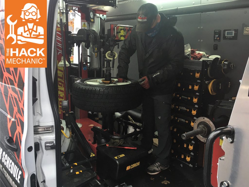 driveway tire service tech mechanic mounts tire