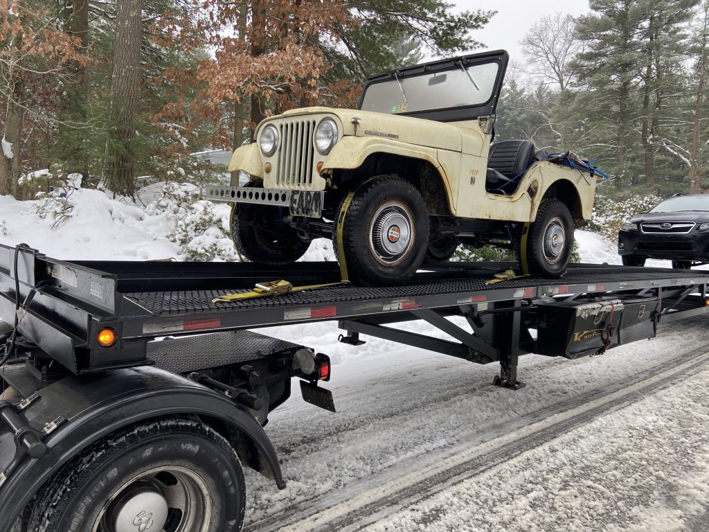 vintage jeep front three-quarter on flatbed trailer