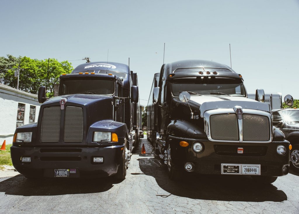 enclosed car hauling semi trucks front