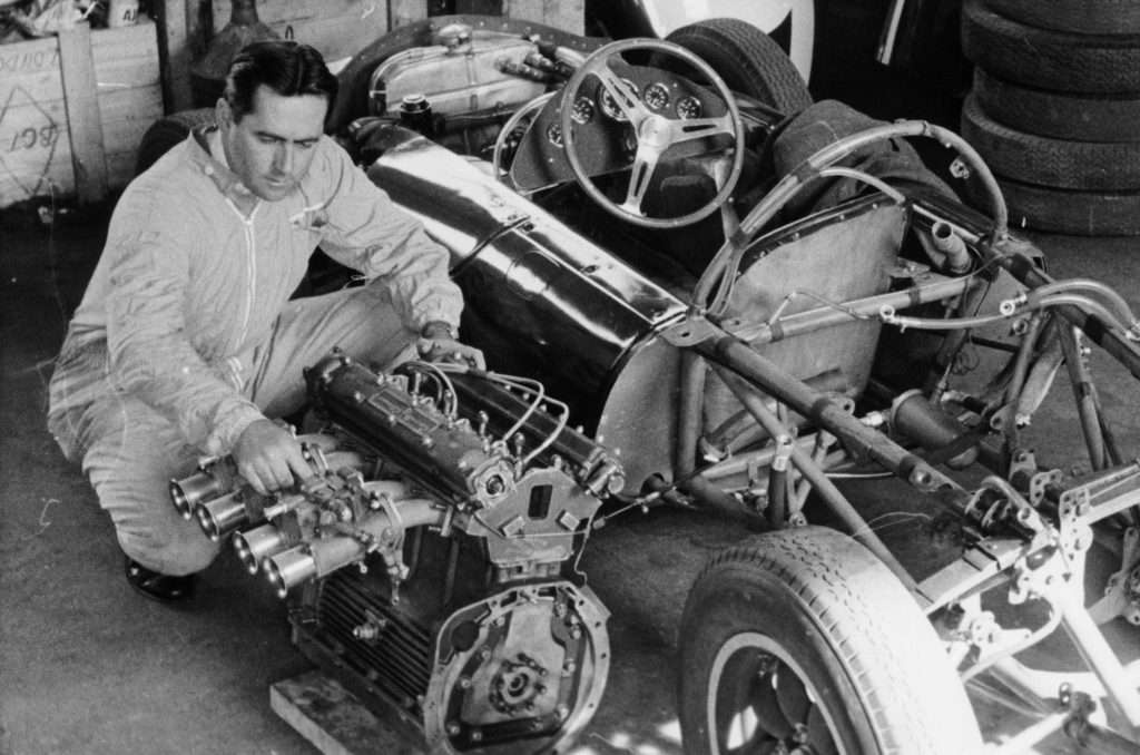 Jack Brabham inspecting engine