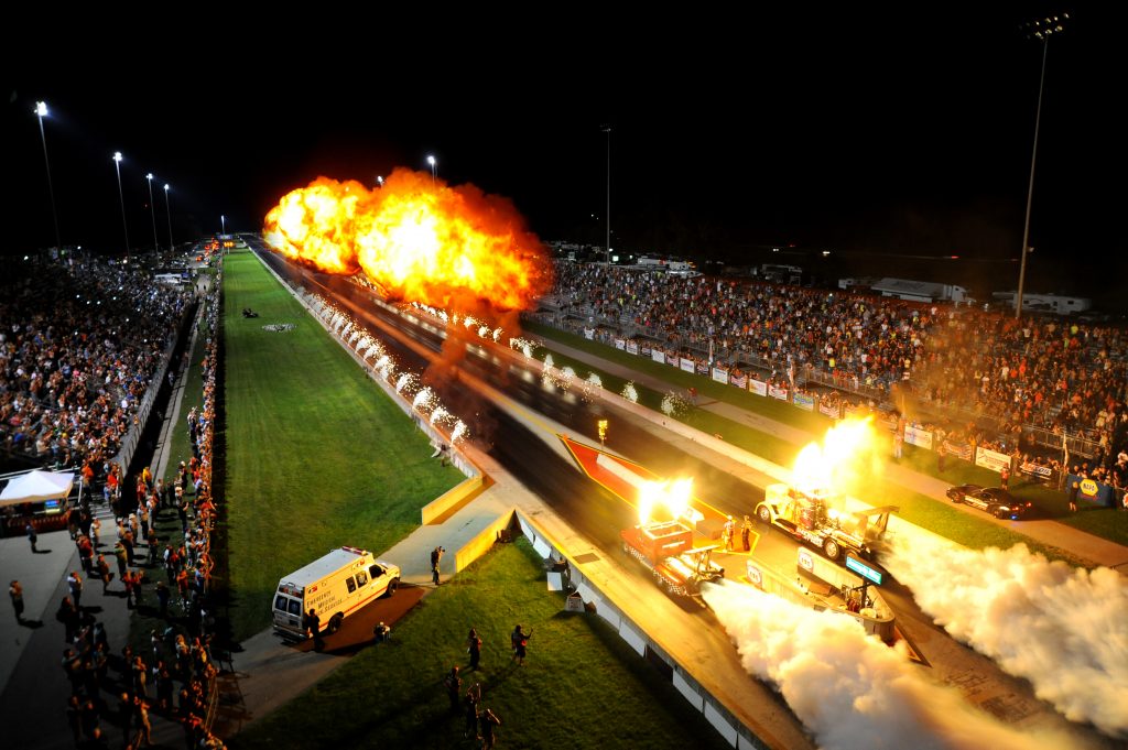 IHRA drag car take off action fire and smoke run aerial view