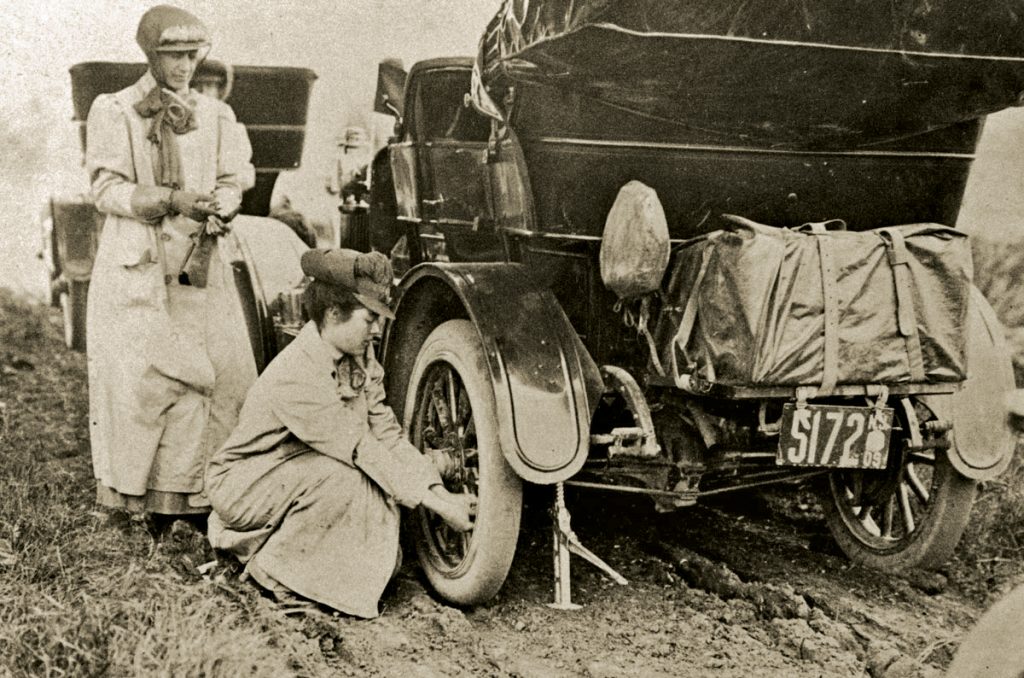 alice ramsey stops kneels changes tire on maxwell automobile