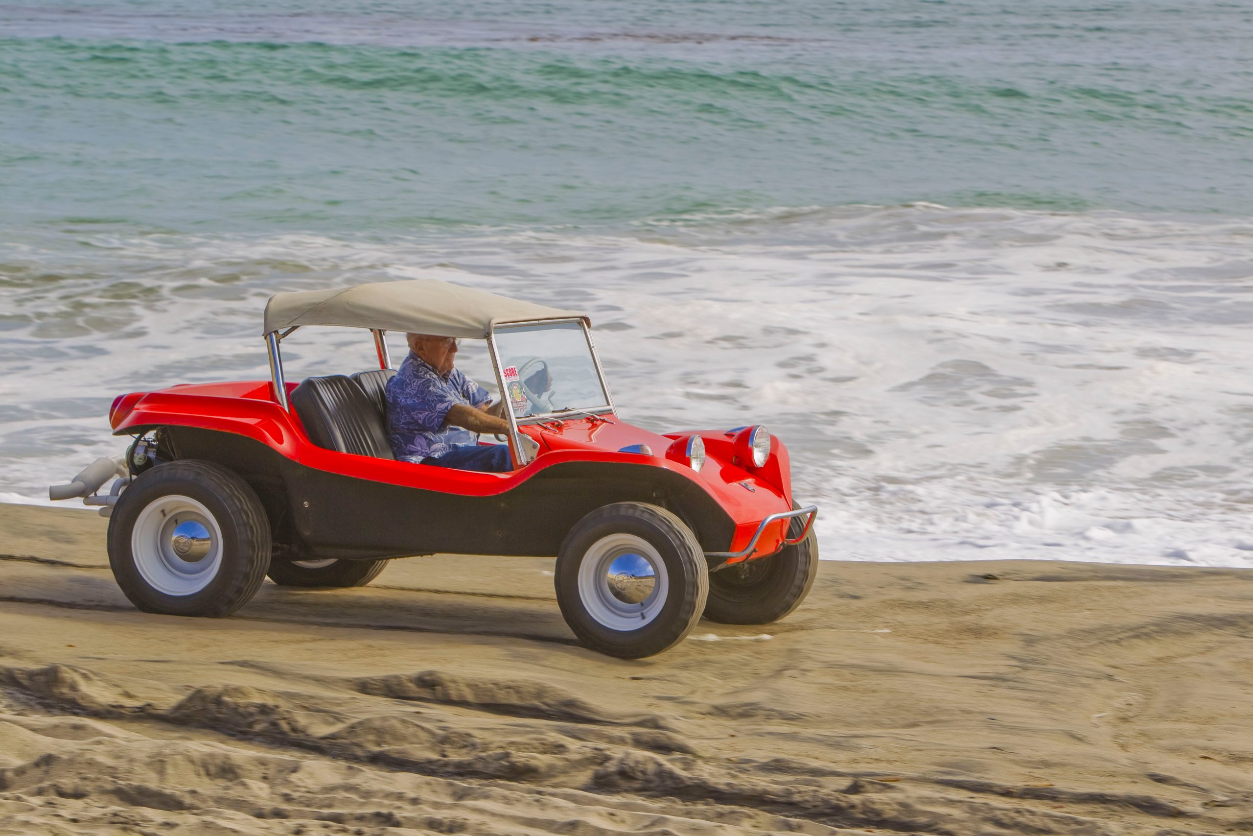 Meyers Manx Dune Buggy front three-quarter on beach bruce at wheel