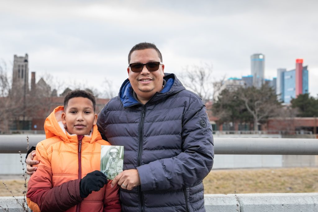 Gregory Qualls and son holding photo detroit