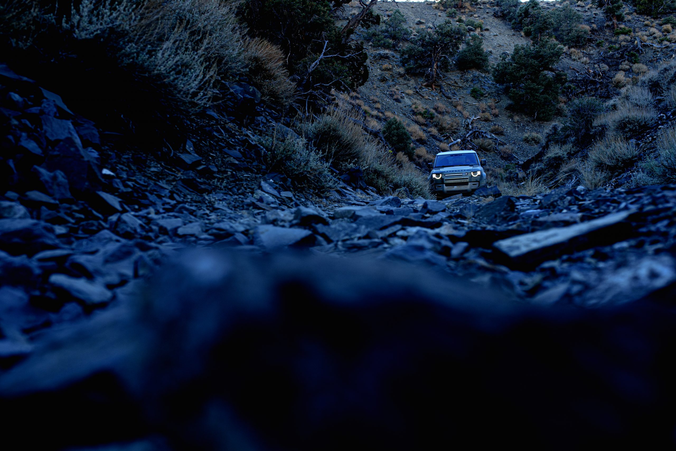 land rover defender front on rocky trail