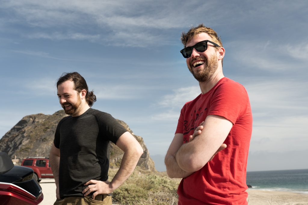 moto riders laughing enjoying californian coast