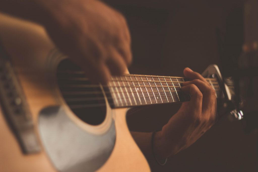 acoustic guitar playing hands detail