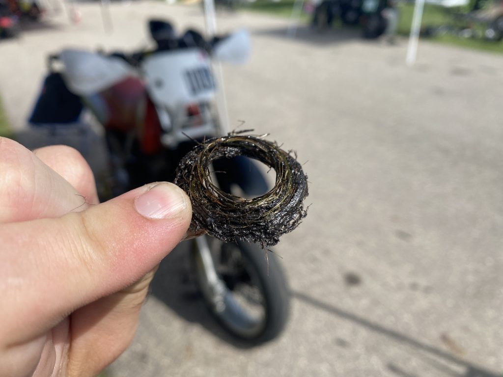Buildup behind XR250R countershaft sprocket