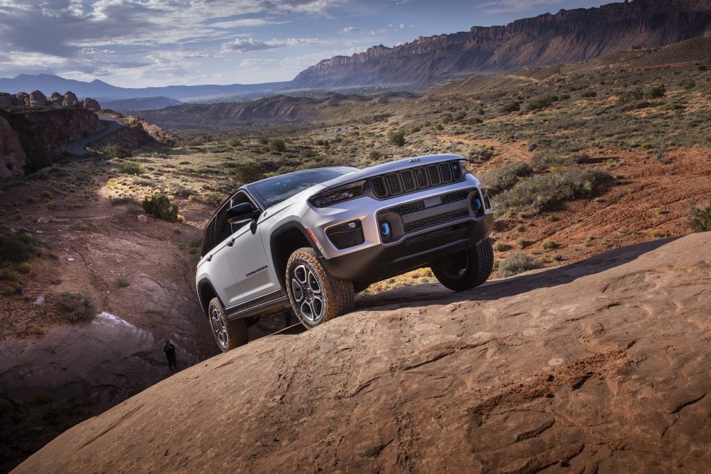 2022 Jeep Grand Cherokee Trailhawk 4xe right front three quarter up rocks