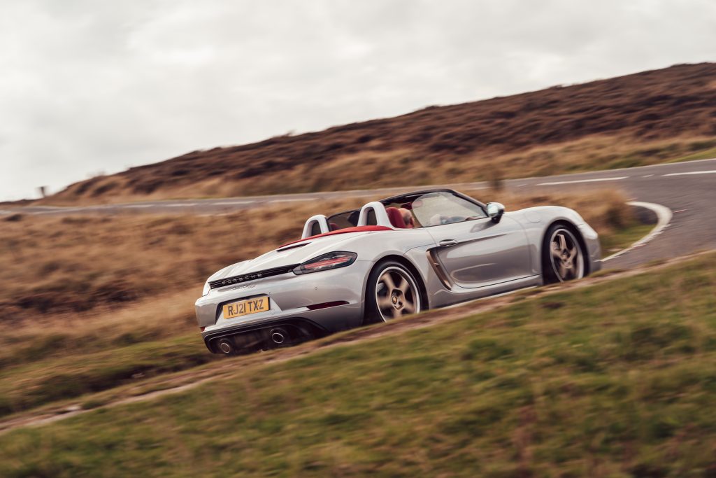 2021 Porsche Boxster 25 Years rear three-quarter driving action