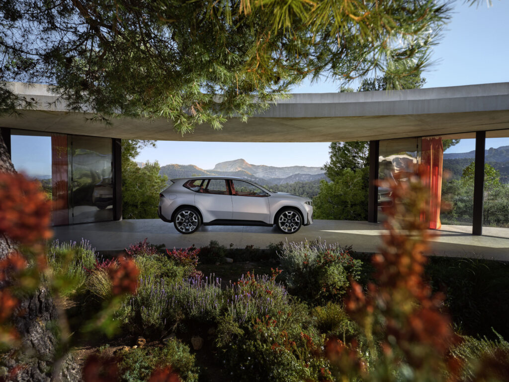 BMW Neue Klasse X exterior side profile near house.