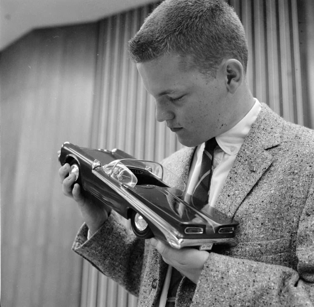 young design student admiring a newly produced model car
