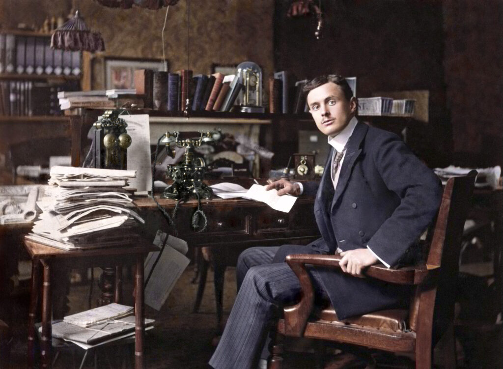C S Rolls sitting at his desk, c 1902.