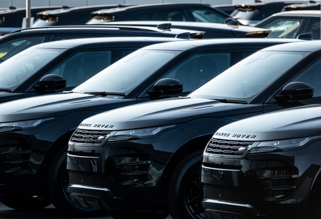 Range Rovers are parked outside